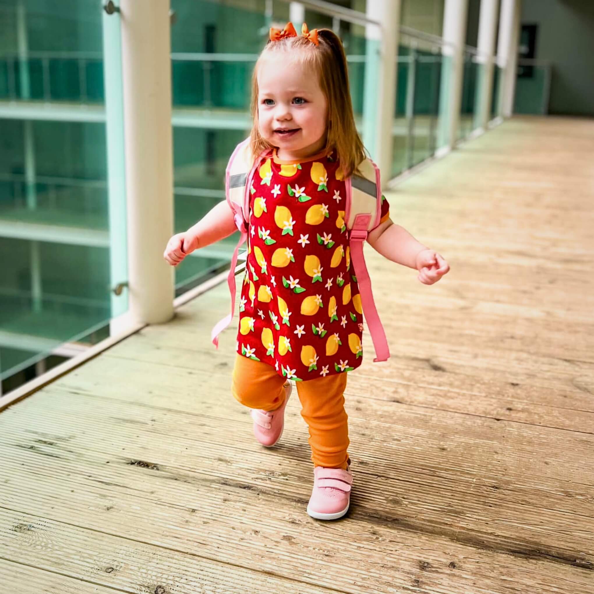 Toddler walking in Pink Barefoot Trainers