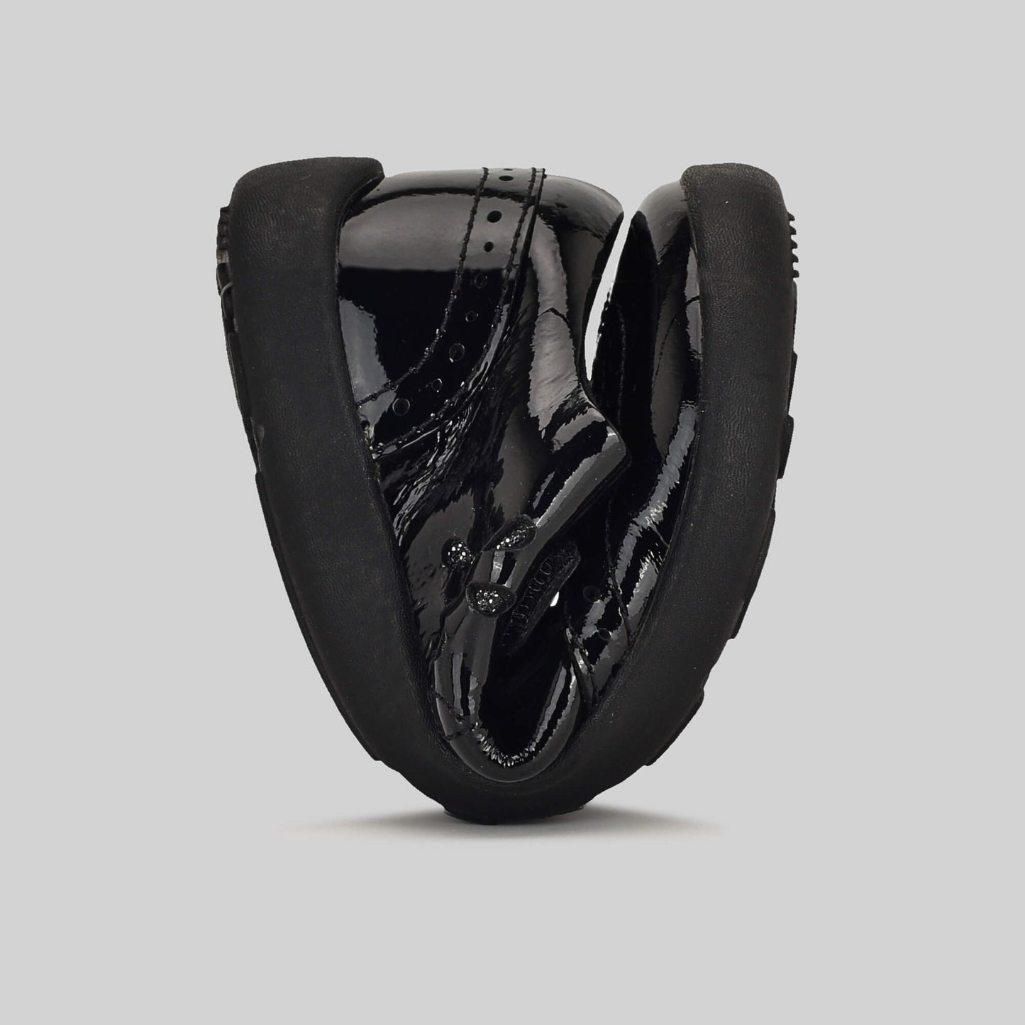 Patent black barefoot girls school shoe - flexed