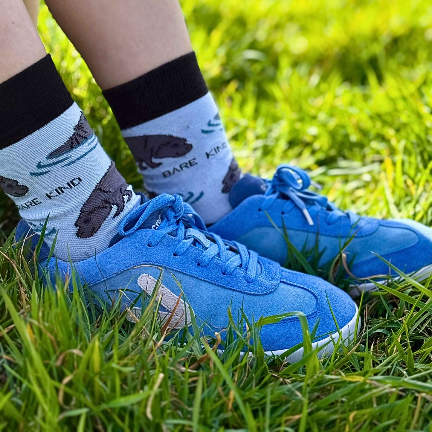 Close up of blue Suede trainer in grass