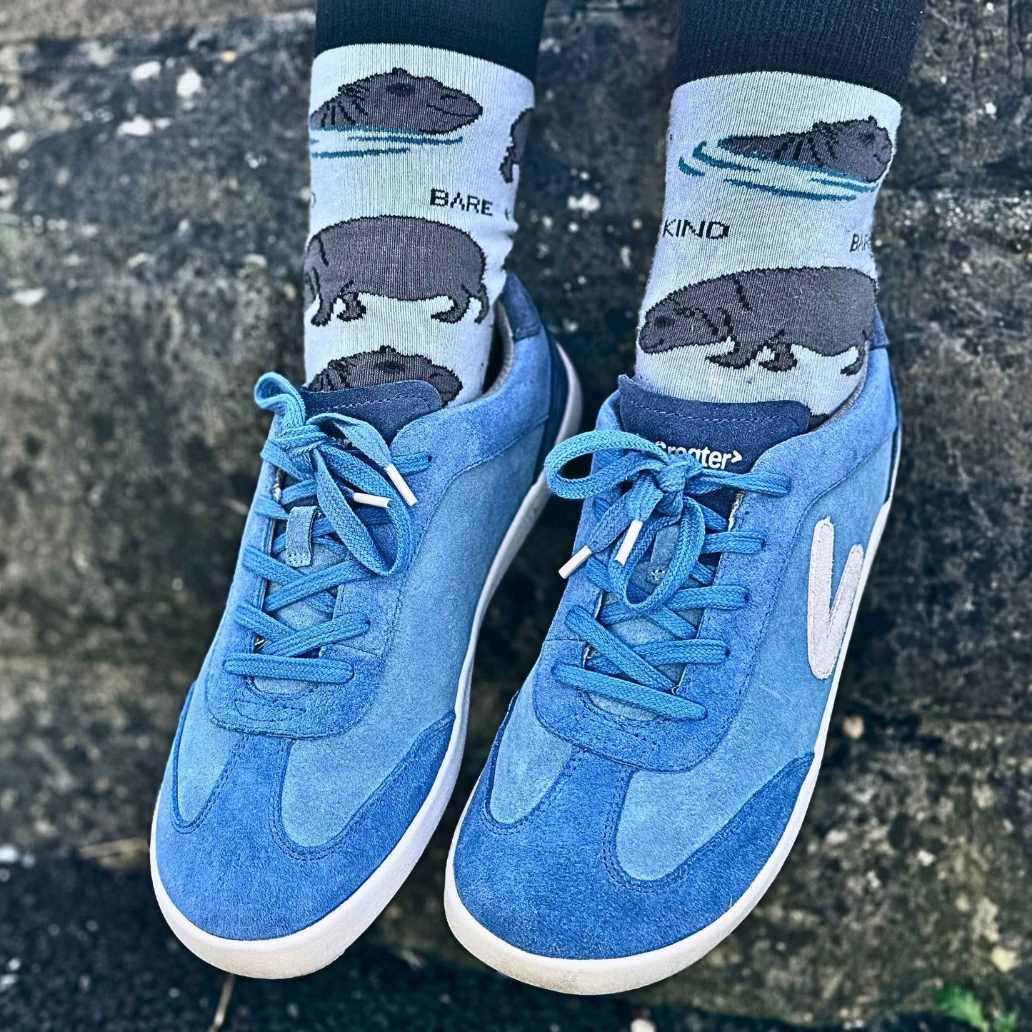 Close up blue suede trainers against wall