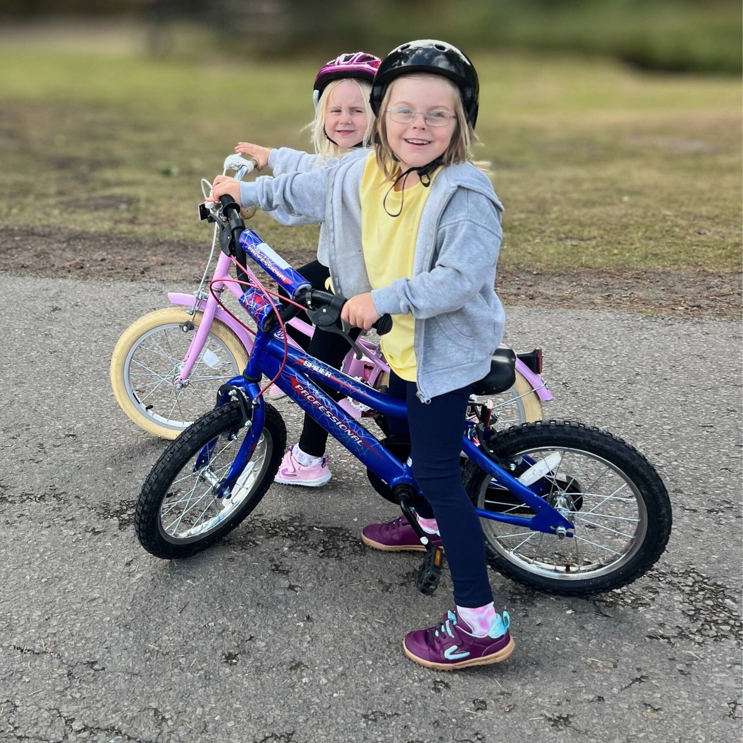 two girls on bike wearing purple barefoot trainers