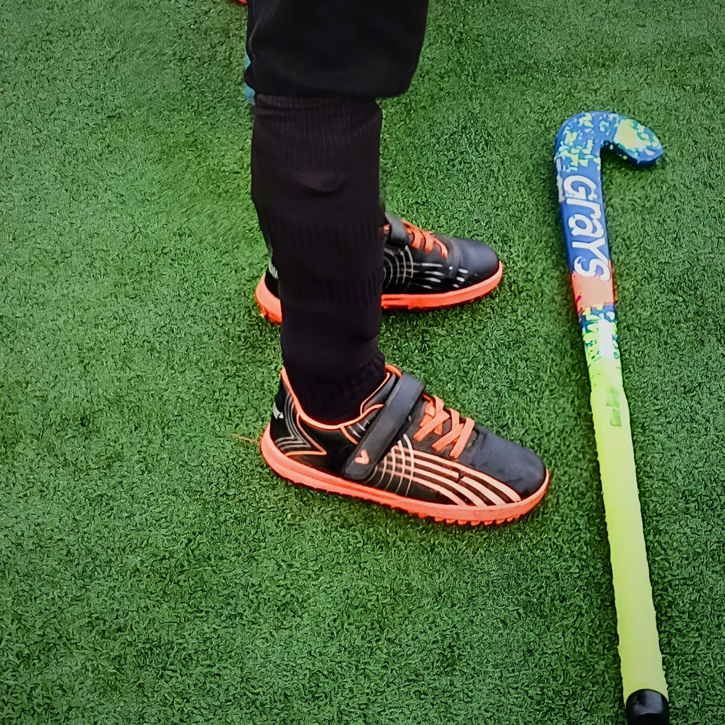 Boy wearing black astros on 3g hockey field