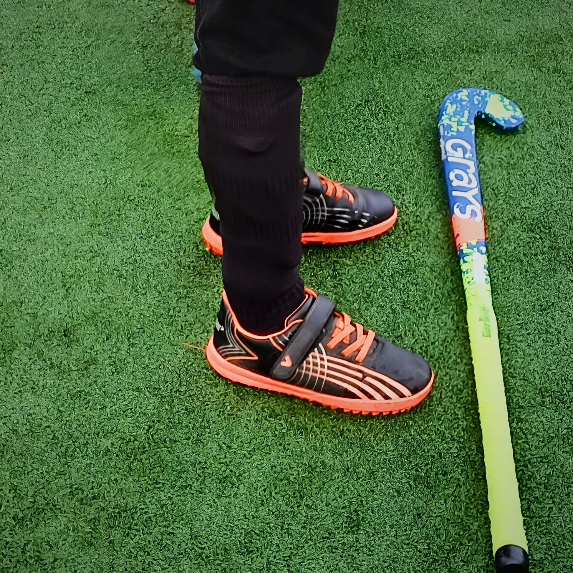 Boy wearing black astros on 3g hockey field