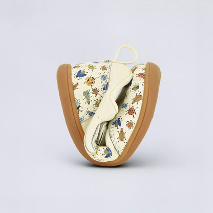 Cream Bug barefoot toddler trainer - flexed
