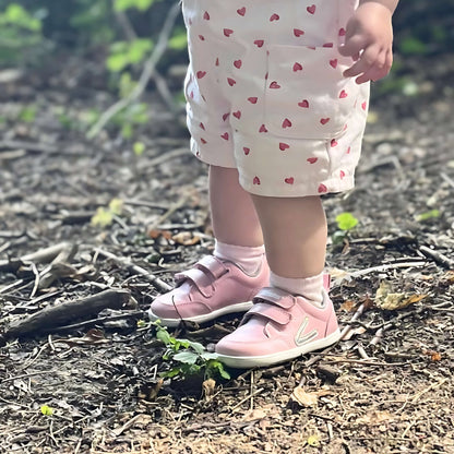 girl wearing pink barefoot trainers in forest
