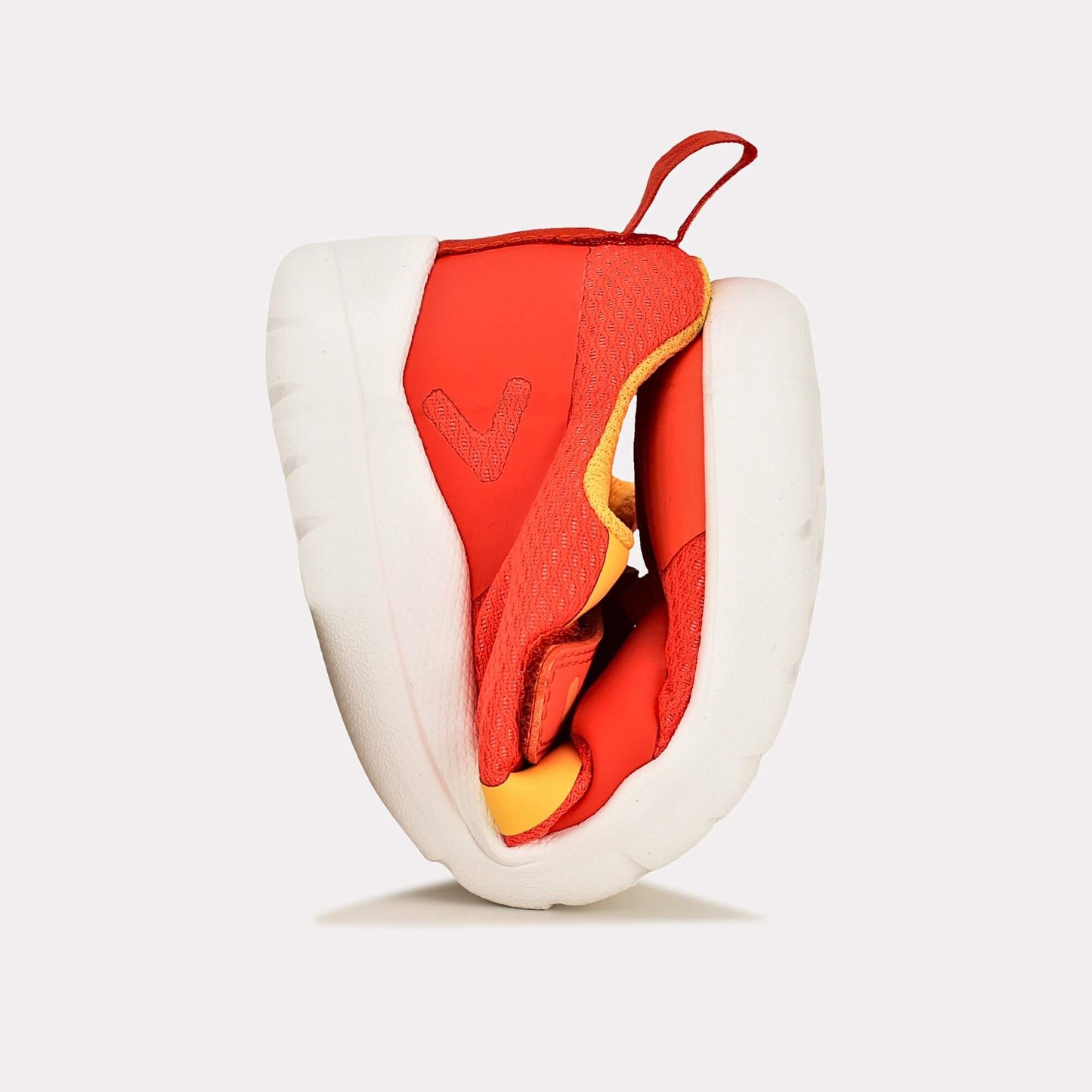 Orange barefoot kids trainer - flexed