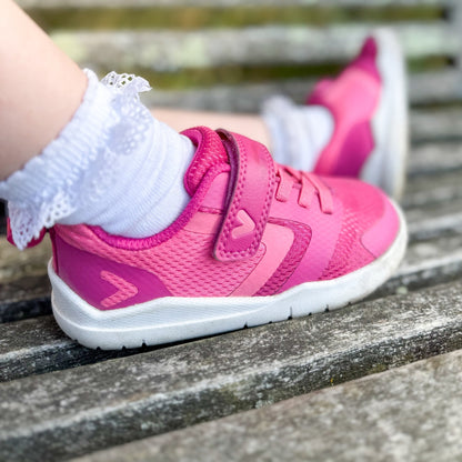 Kids wearing pink barefoot trainers close up