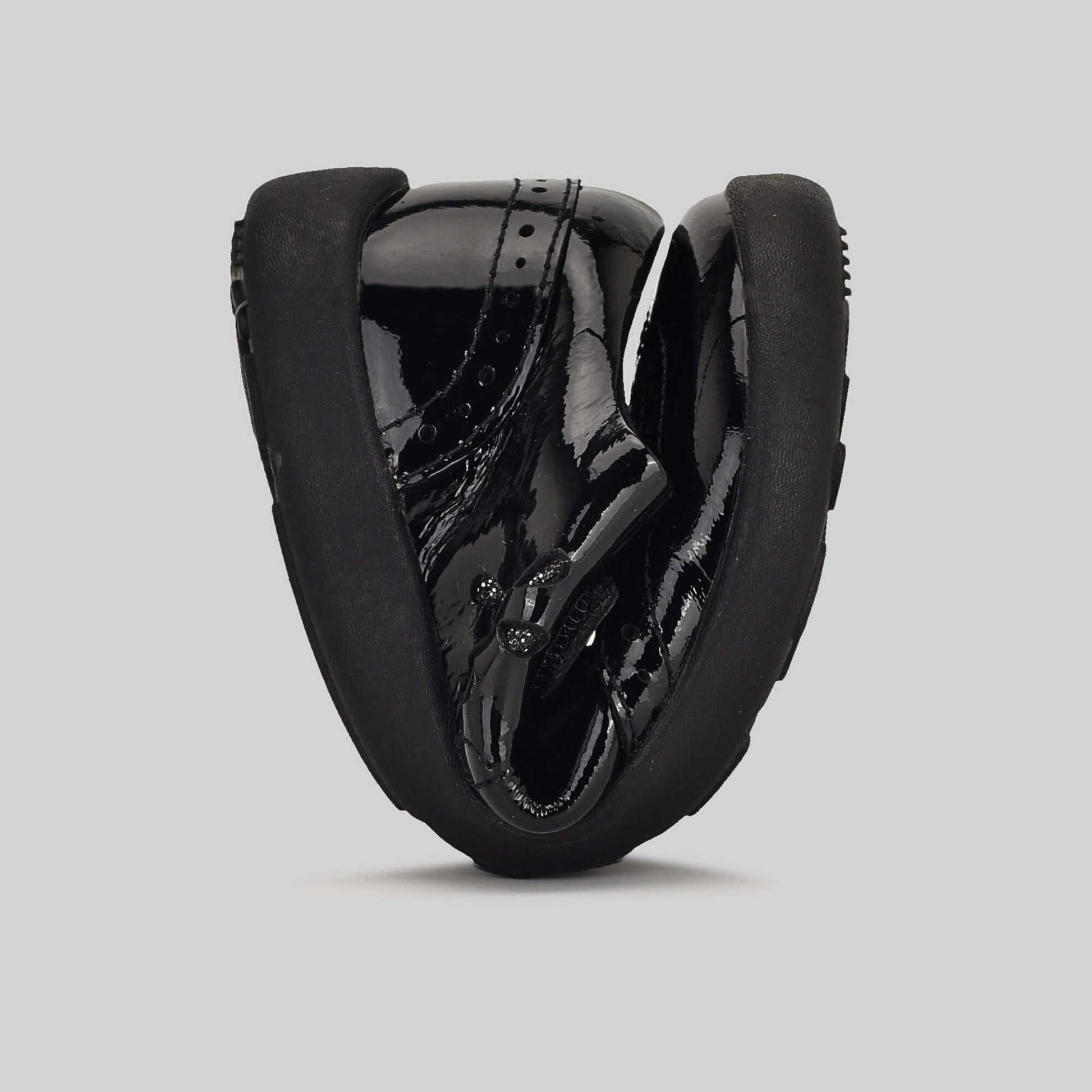 Patent black barefoot girls school shoe - flexed