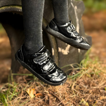 Close up black girls school shoes in forest