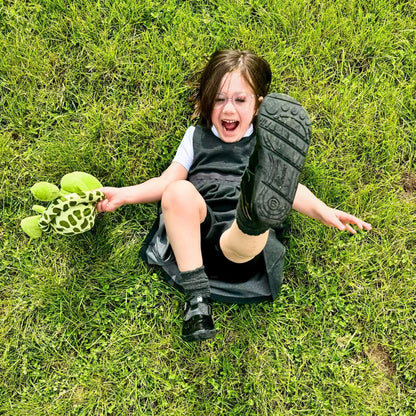 School girl wearing black T-bar shoes in park