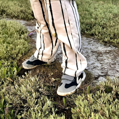 Boy wearing grey black trainers standing in park