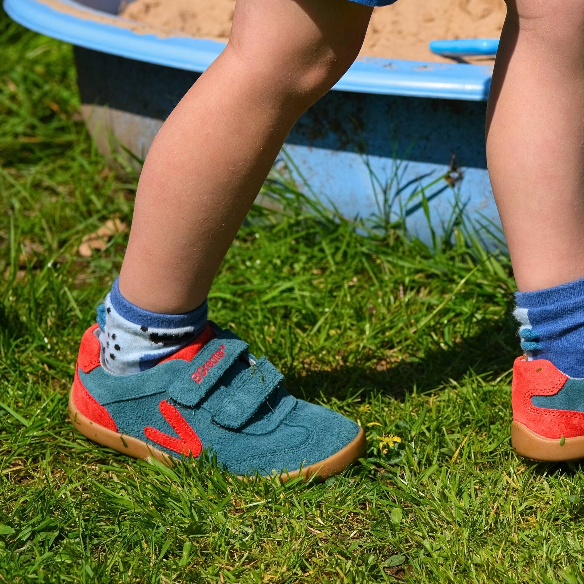 Boy in garden wearing green barefoot trainers