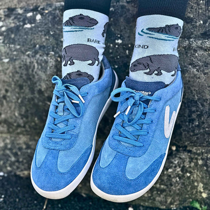 Close up blue suede trainers against wall